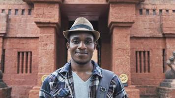 Man standing outdoors smiling and looking at camera video