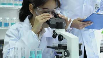 Asian Scientist Using a Microscope at A Medical Center video