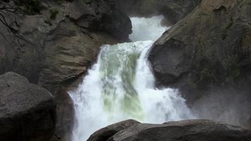 Ein Wasserfall sprudelt über große Felsen video