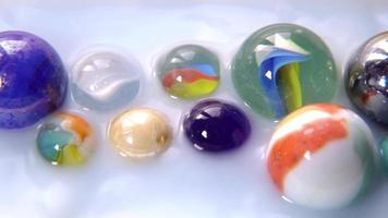 Falling Marbles On Multicolored Marbles Inside Water video