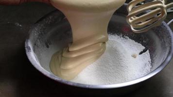 Pouring Dough into White Powder