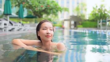 Young asian woman inside pool video