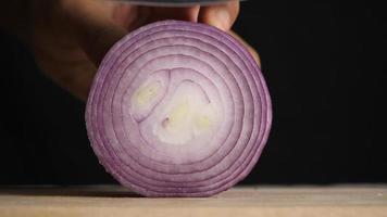 Men's Hand Slicing a Shallot with A Kitchen Knife video