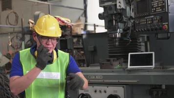A young male worker yelling on a radio communicator  video
