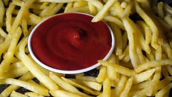 Men's hand dip the french fries in tomato sauce video