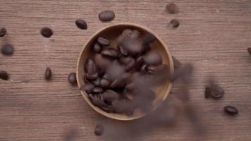 Pouring coffee beans into the bowl, slow motion