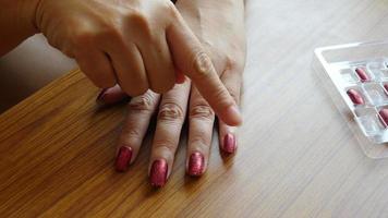 Artificial red color nail placement video