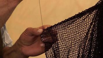 Man Knitting Fishnet video