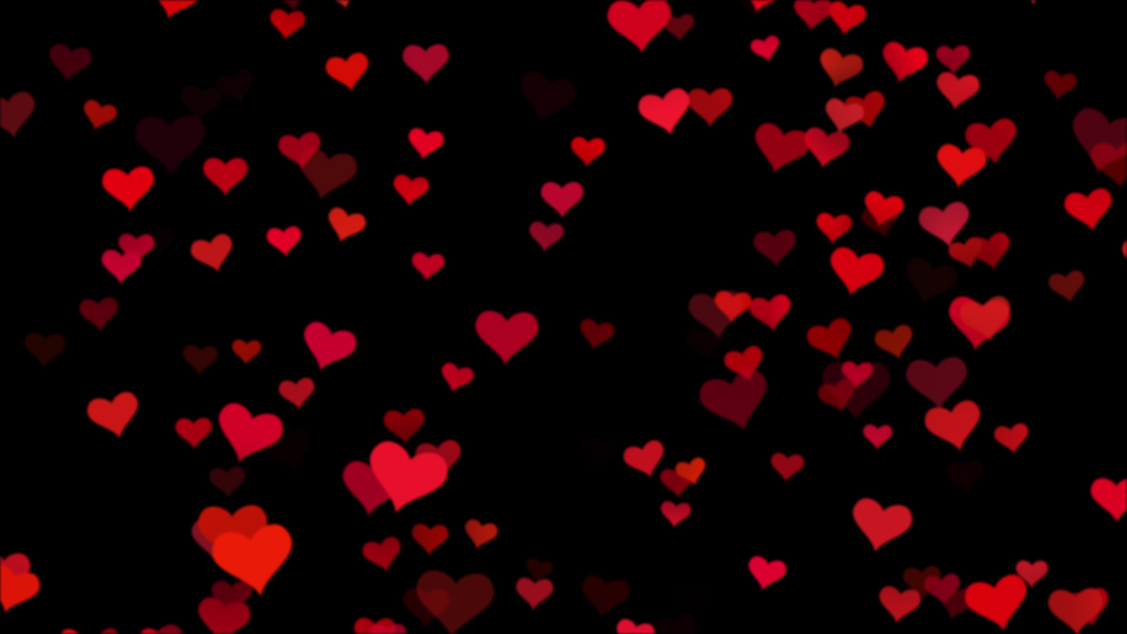 Seamless loop soft focused small red hearts over black background 2021218  Stock Video at Vecteezy