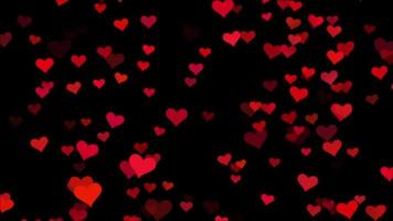 Seamless loop soft focused small red hearts over black background  video
