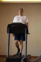 Middle-aged man working out on a treadmill photo