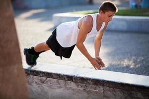 Teenager performing push-ups photo