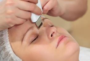 Woman getting an ultrasonic facial cleanse photo