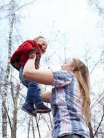 Mother holding son outside photo