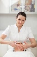 Cosmetician giving a facial massage photo