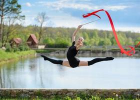 Young gymnast leaping with a ribbon photo