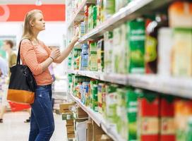 Young woman shopping for juice photo