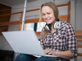 Woman spending leisure time on a laptop at home photo