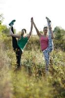 Two women exercising together outside photo