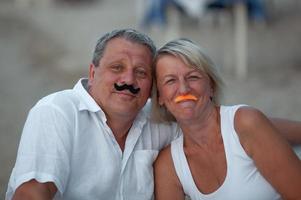 Couple with pretend mustaches photo