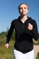 Young woman running outside photo