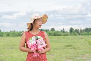 Young woman relaxing in a green field photo