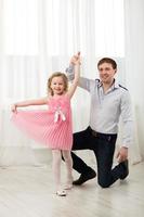 Daughter dancing with father photo