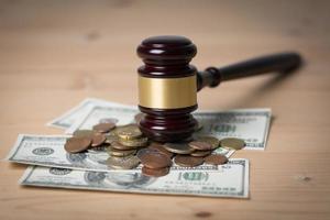 Concept of legal court gavel on assorted cash, close-up photo