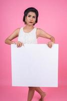 Portrait of a fashionable woman displaying a white banner photo