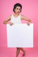 Portrait of a fashionable woman displaying a white banner photo