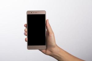 Close Up of a woman holding on mobile phone isolated on white background photo