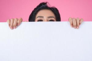 Portrait of a fashionable woman displaying a white banner photo