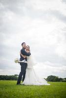 Pretty bride and handsome groom gorgeous posting in the nature photo