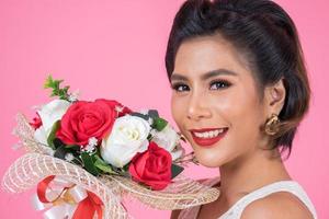 Portrait of a beautiful woman with bouquet of flowers photo