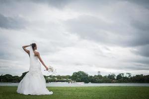 hermosa novia con flores, maquillaje de boda y peinado foto