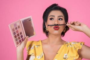 Portrait of a woman with makeup and cosmetic brush photo