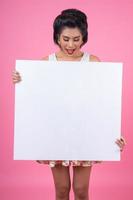 Portrait of a fashionable woman displaying a white banner photo