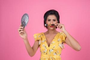 Fashionable woman with makeup and mirror photo