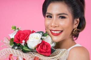 Portrait of a beautiful woman with bouquet of flowers photo