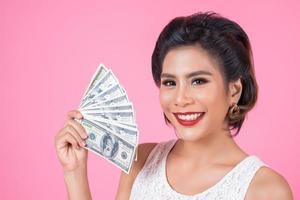 Happy beautiful woman holding dollars photo