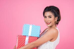 Beautiful happy woman with surprise gift boxes photo