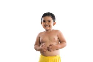 Little boy standing in studio isolated on white background photo