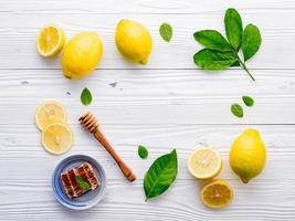 Lemon and honey on a white wooden background photo