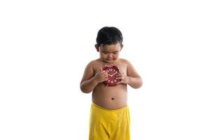 Little Asian boy holding a big red clock, isolated on white background photo