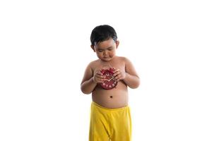 Little Asian boy holding a big red clock, isolated on white background photo