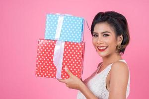 Beautiful happy woman with surprise gift boxes photo