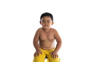 Portrait of little boy sitting isolated on white background photo