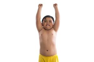 Funny little boy showing strong muscles isolated on white background photo