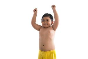 Funny little boy showing strong muscles isolated on white background photo