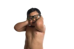 Happy little cute Asian boy wearing glasses with happy face on white background photo